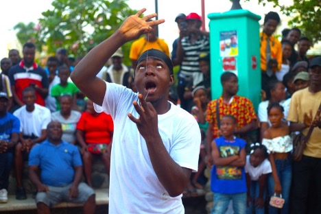 Ericson Germéus, a circus performer who also goes by Smoky G, inserted a string in his nose then pulled it from the inside of his mouth. Photo by Onz Chéry/ The Haitian Times 